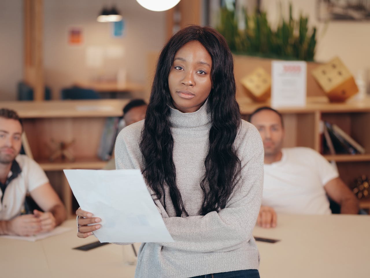 Diverse group in a modern office setting, focused on collaboration.